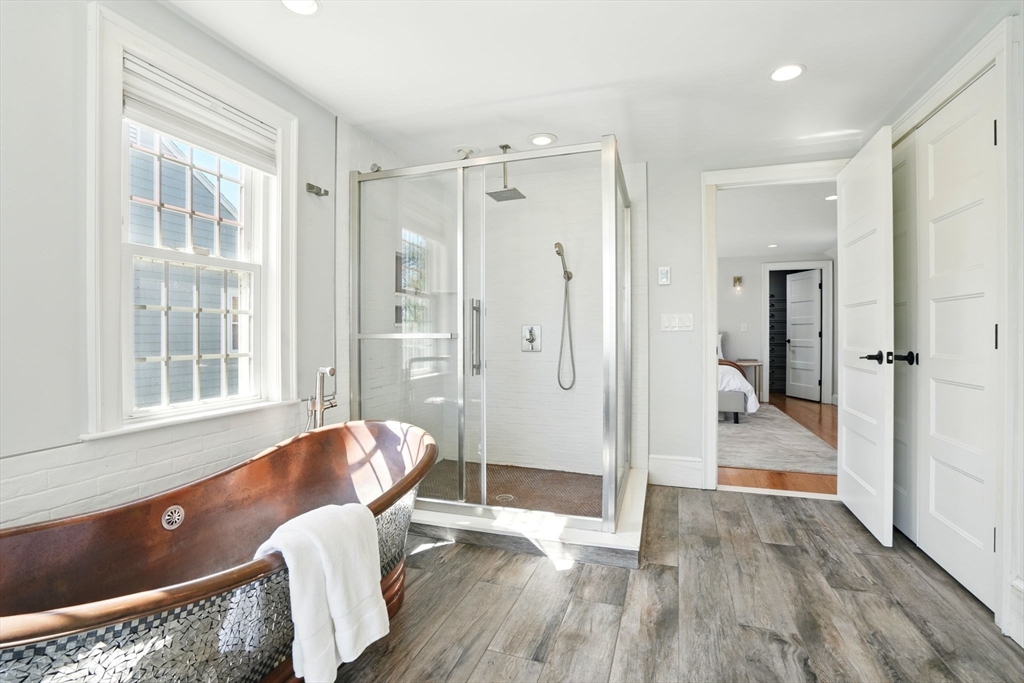 181 Grove Street Cambridge, MA 02138 - Photo 10 of 22 a view of a bathroom with tub shower and windows