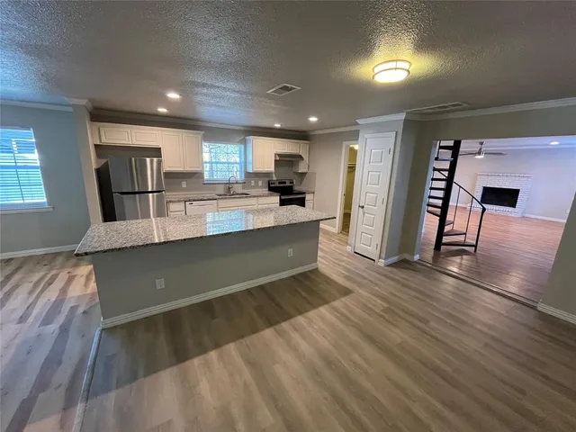 a view of a room with wooden floor and staircase