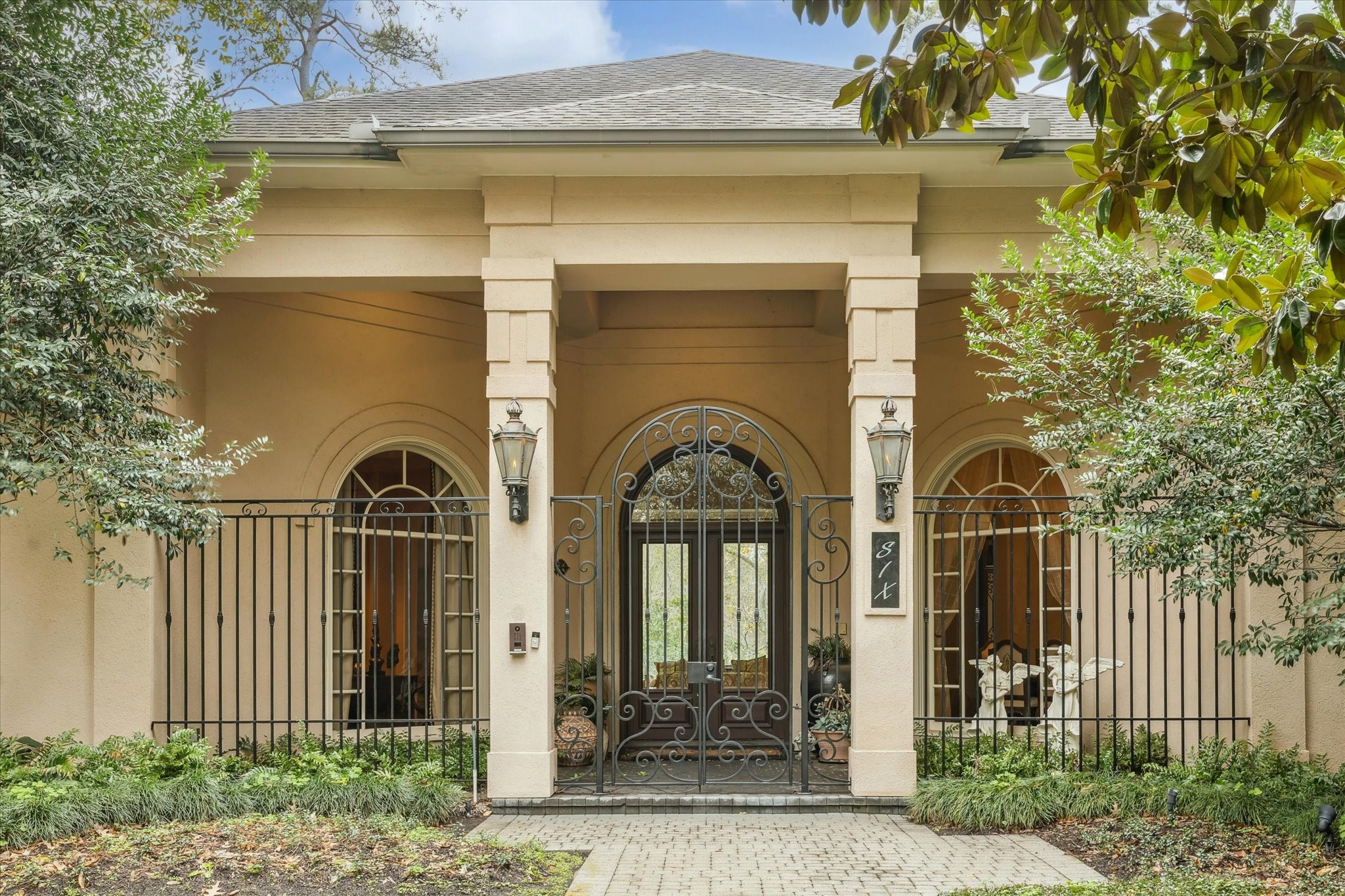 6 Mott Lane Houston, TX 77024 - Photo 1 of 49 a front view of a house with a garden