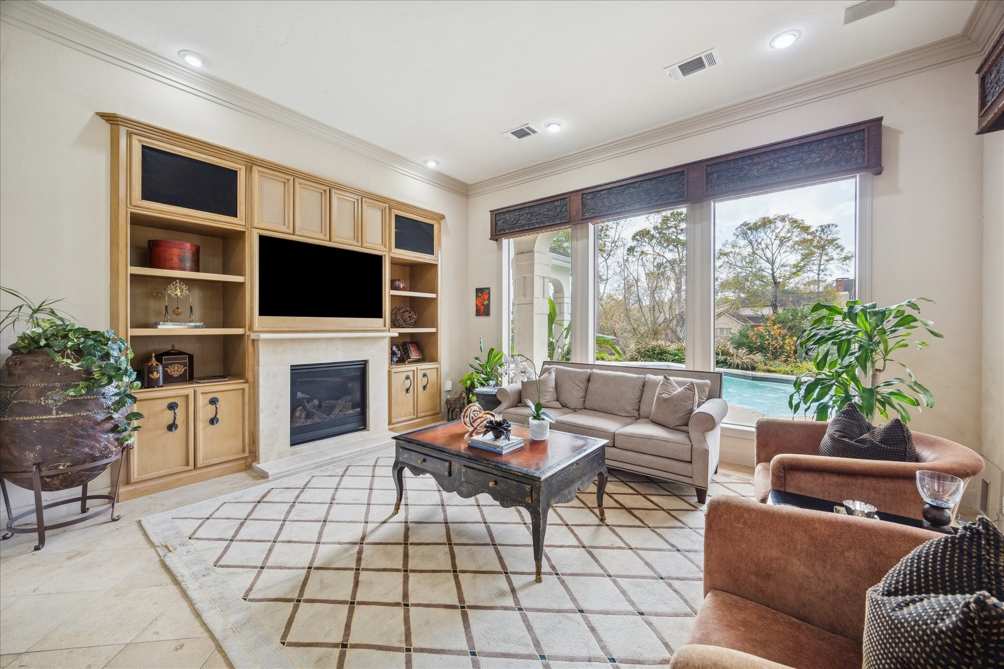 6 Mott Lane Houston, TX 77024 - Photo 15 of 49 a living room with furniture a flat screen tv and a fireplace