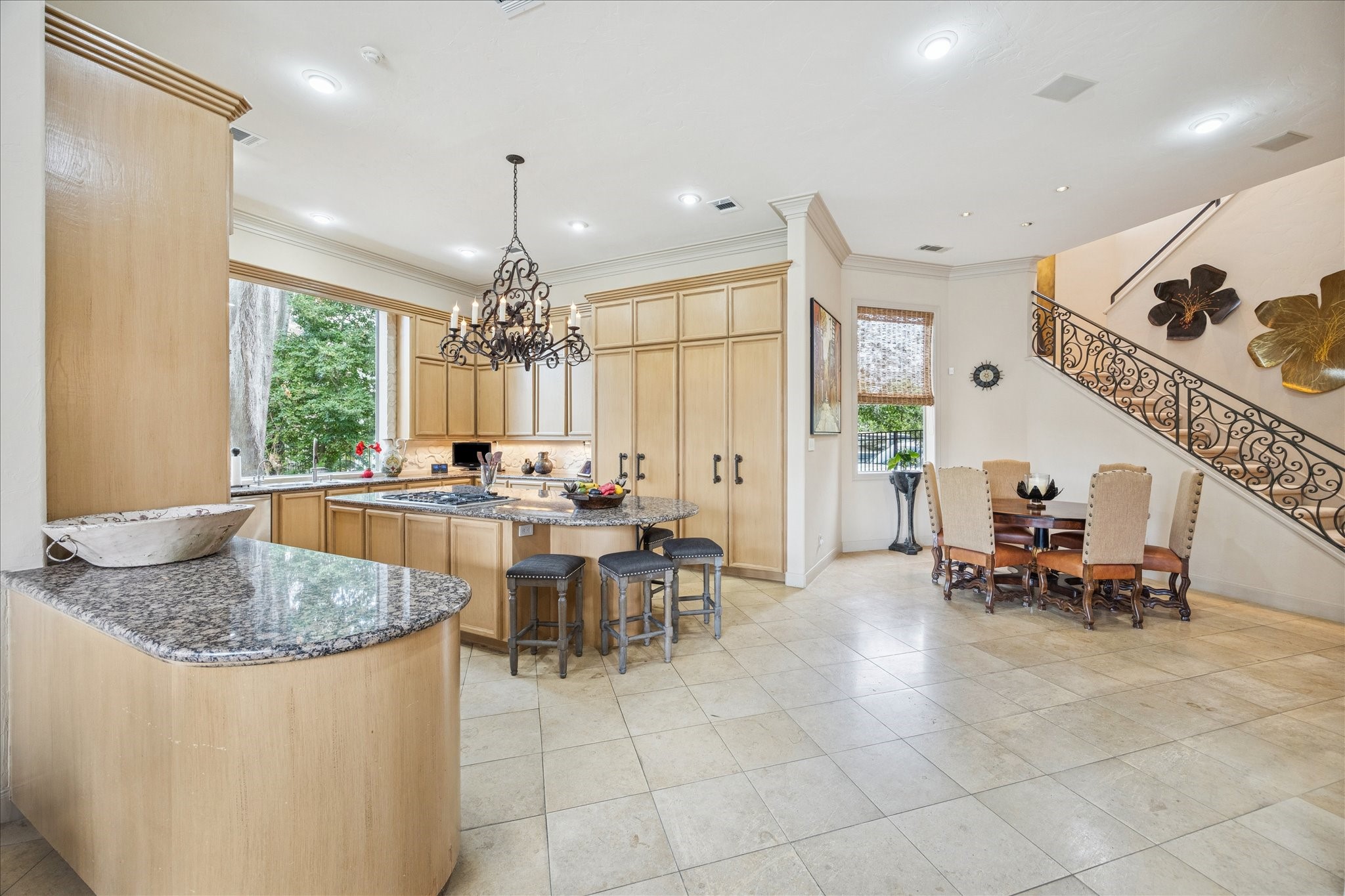 6 Mott Lane Houston, TX 77024 - Photo 19 of 49 a kitchen with a dining table chairs sink and natural light