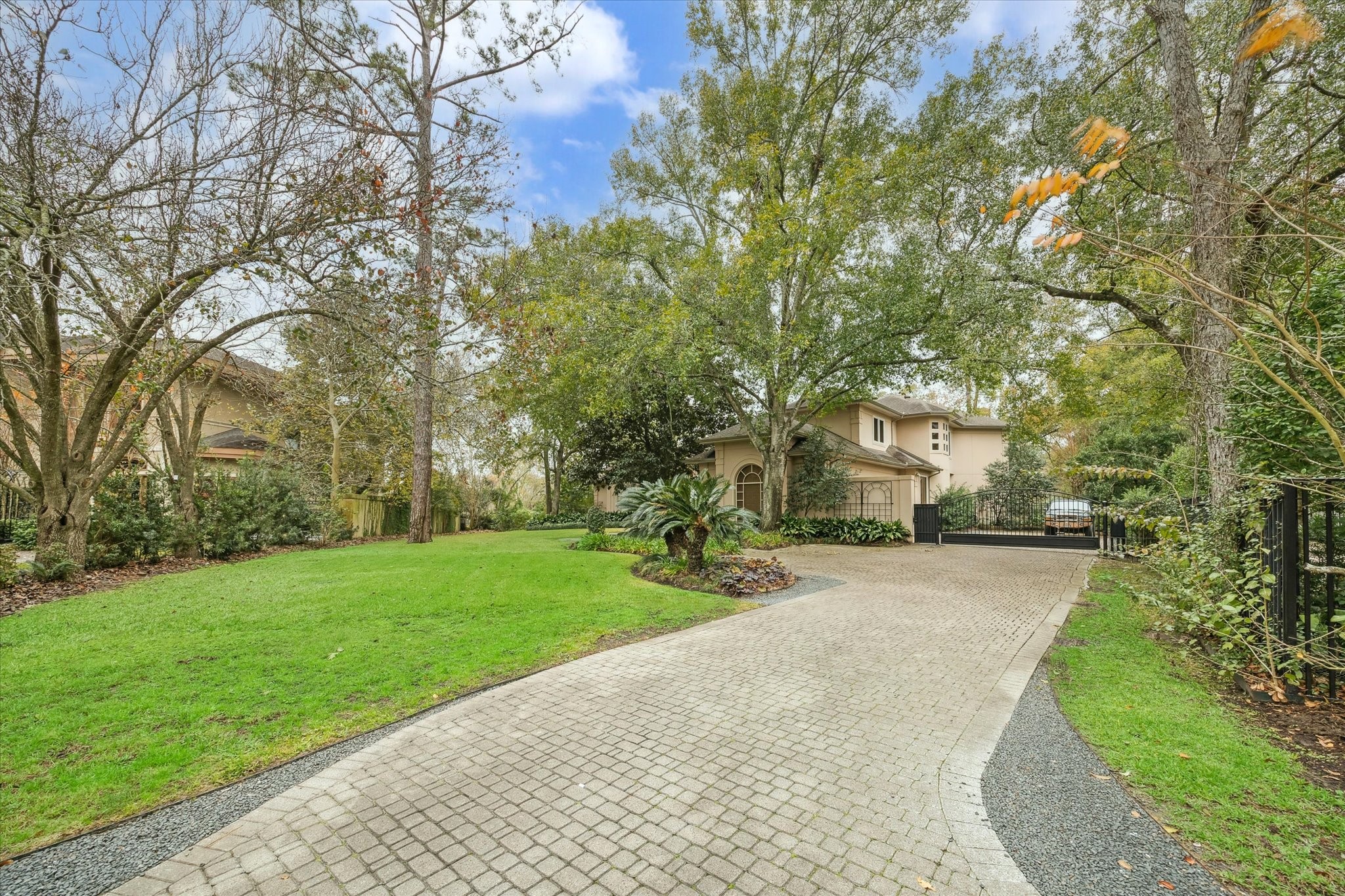 6 Mott Lane Houston, TX 77024 - Photo 3 of 49 a front view of a house with a yard and pathway