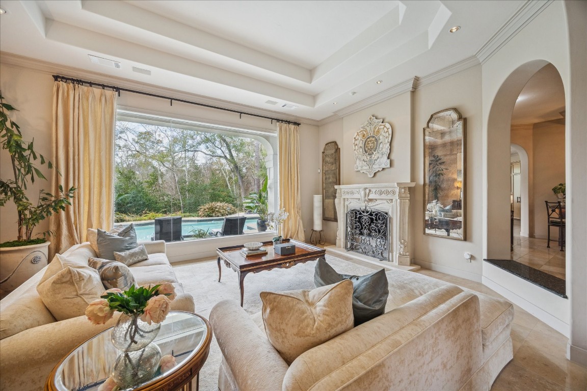 6 Mott Lane Houston, TX 77024 - Photo 6 of 47 Living Room w stone mantel overlooking pool and backyard