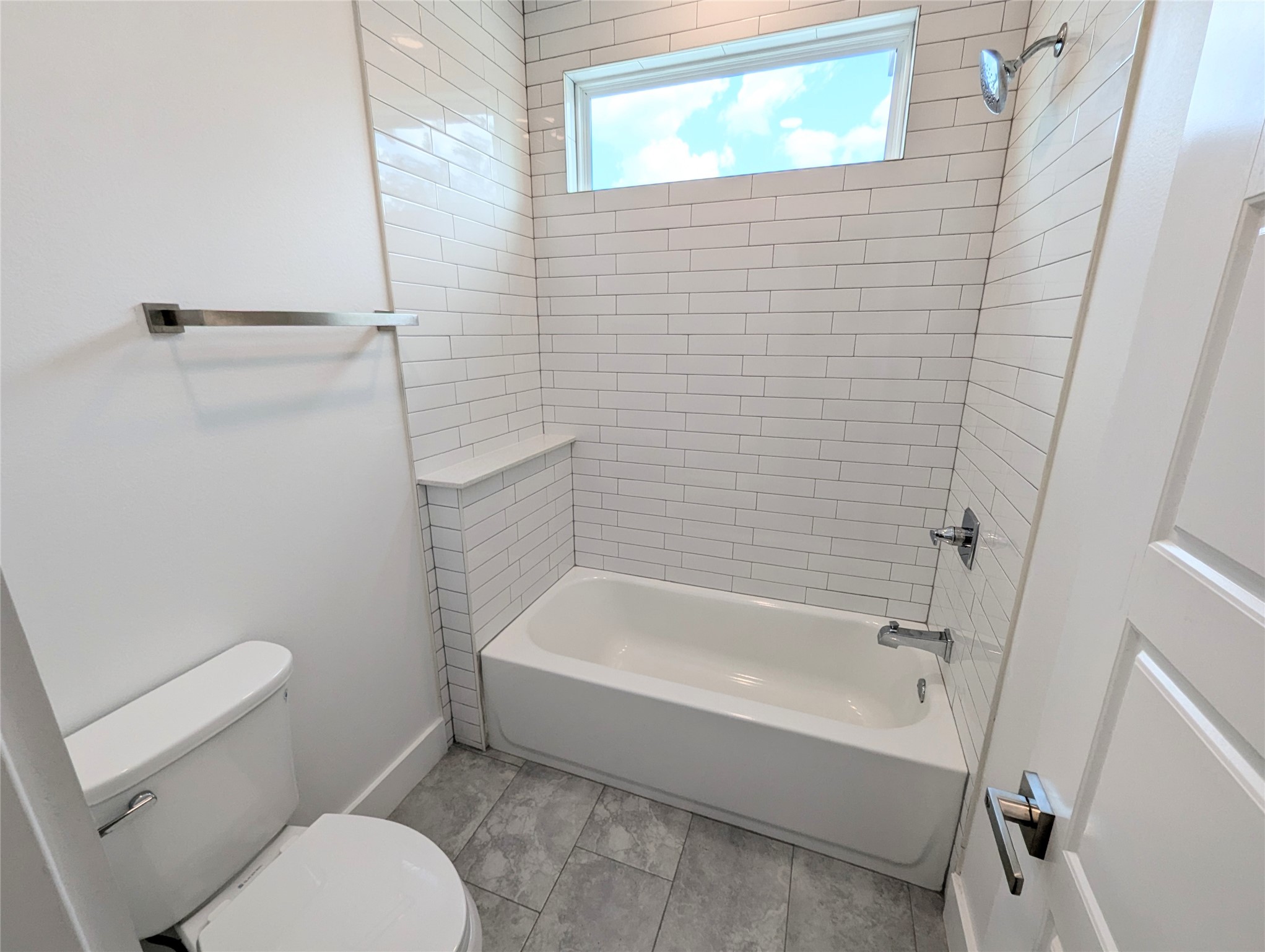 4913 Fisk Street Houston, TX 77009 - Photo 24 of 27 a bathroom with a toilet and a bath tub
