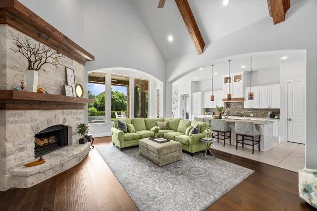 a living room with furniture fireplace and window