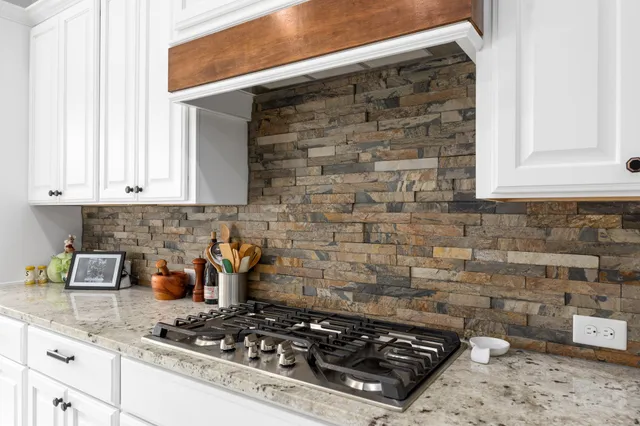 a kitchen with a stove a sink and cabinets