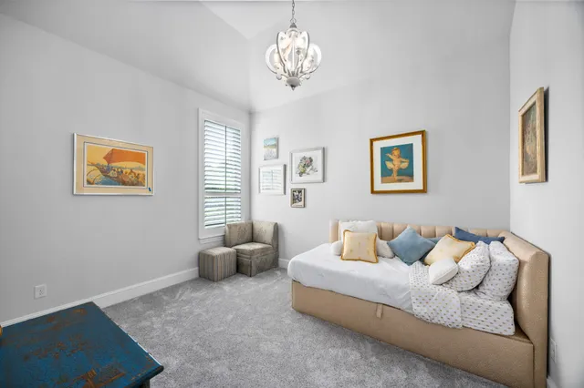 a bedroom with furniture and a chandelier