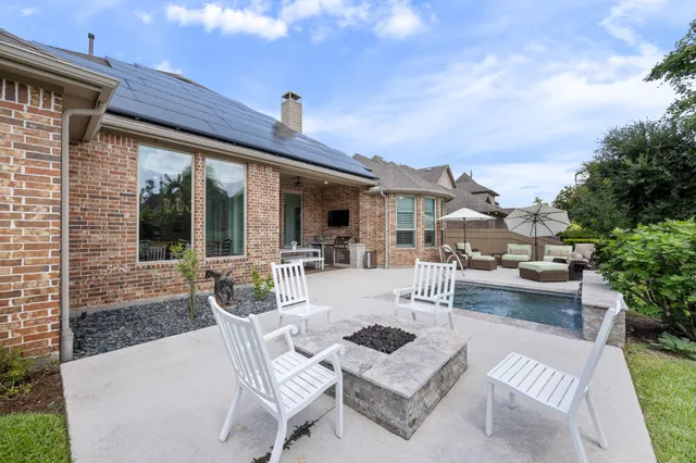 a view of a patio with couches table and chairs and potted plants