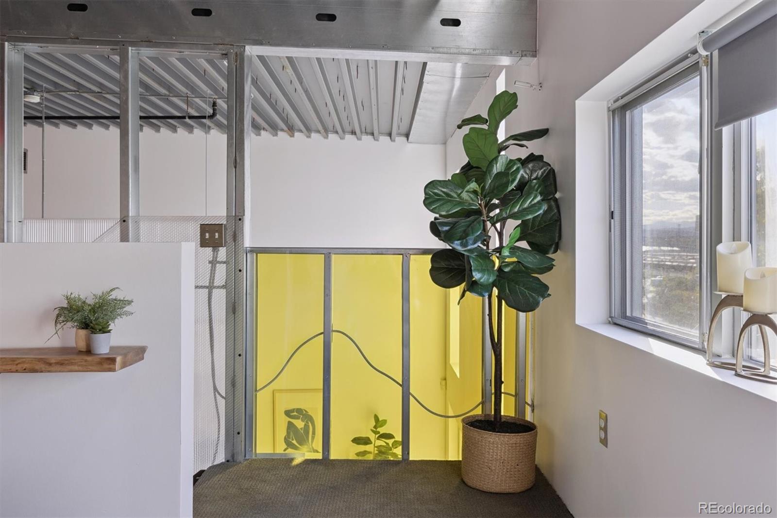 3457 Ringsby Court, Unit 320 Denver, CO 80216 - Photo 11 of 41 a vase of flowers sitting on a table with painted walls