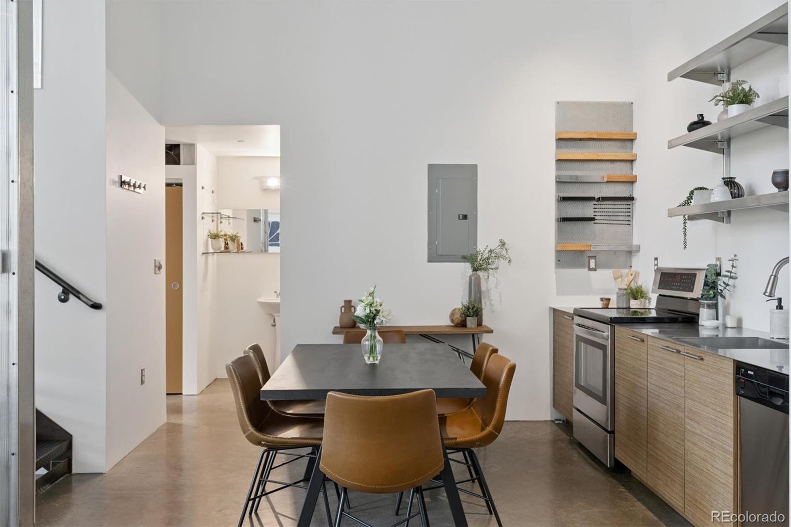 3457 Ringsby Court, Unit 320 Denver, CO 80216 - Photo 20 of 41 a view of a dining room with furniture