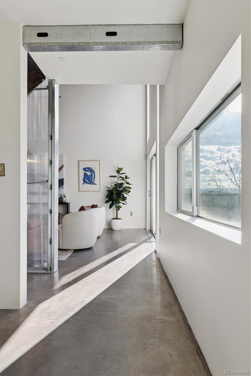 3457 Ringsby Court, Unit 320 Denver, CO 80216 - Photo 21 of 41 a view of a big room with large windows