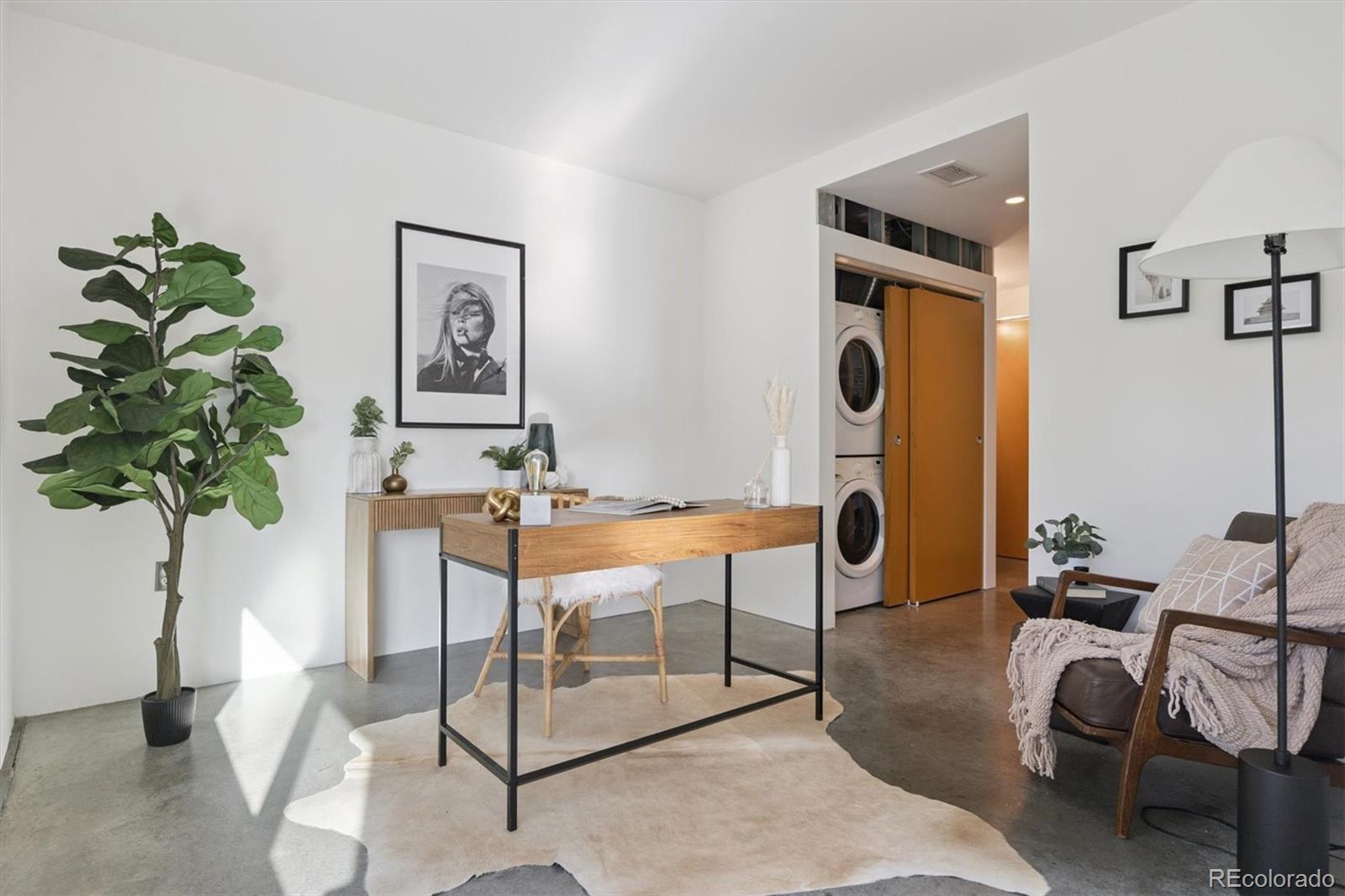 3457 Ringsby Court, Unit 320 Denver, CO 80216 - Photo 24 of 41 a view of a livingroom with furniture and a potted plant