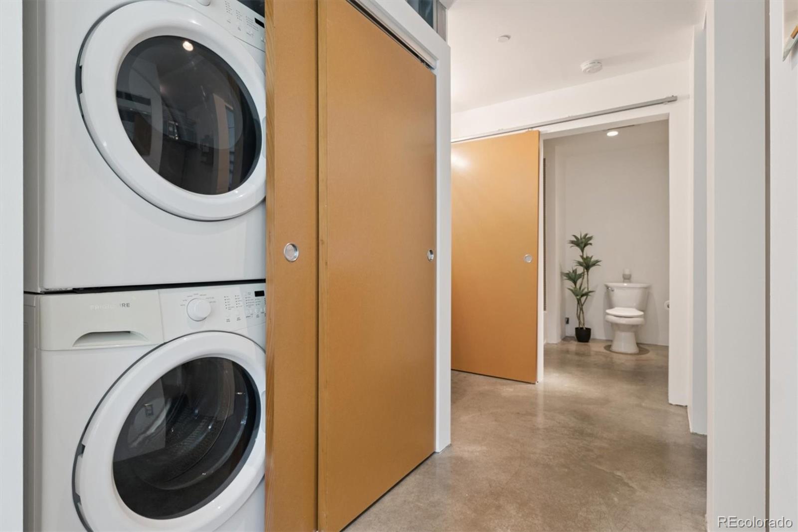 3457 Ringsby Court, Unit 320 Denver, CO 80216 - Photo 28 of 41 a view of a hallway with washer and dryer