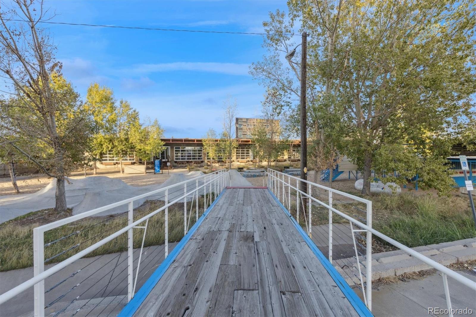 3457 Ringsby Court, Unit 320 Denver, CO 80216 - Photo 40 of 41 a view of a balcony with wooden floor and fence