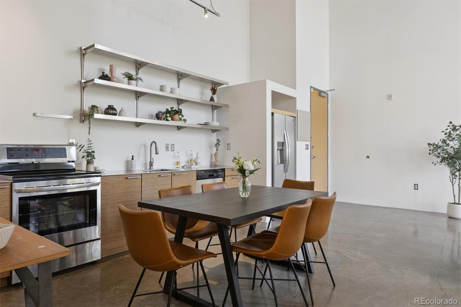 3457 Ringsby Court, Unit 320 Denver, CO 80216 - Photo 6 of 41 a view of a dining room with furniture and wooden floor