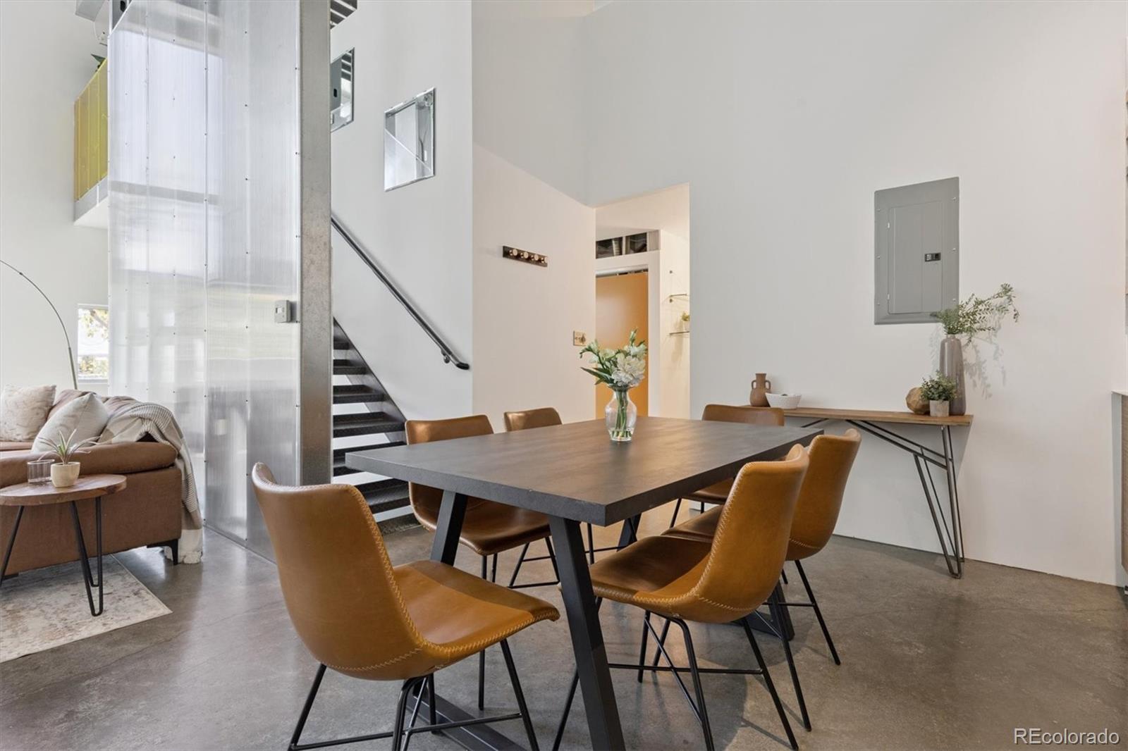 3457 Ringsby Court, Unit 320 Denver, CO 80216 - Photo 8 of 41 a view of a dining room with furniture and wooden floor