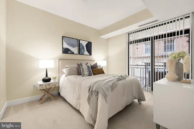 a bedroom with a large bed and a large window