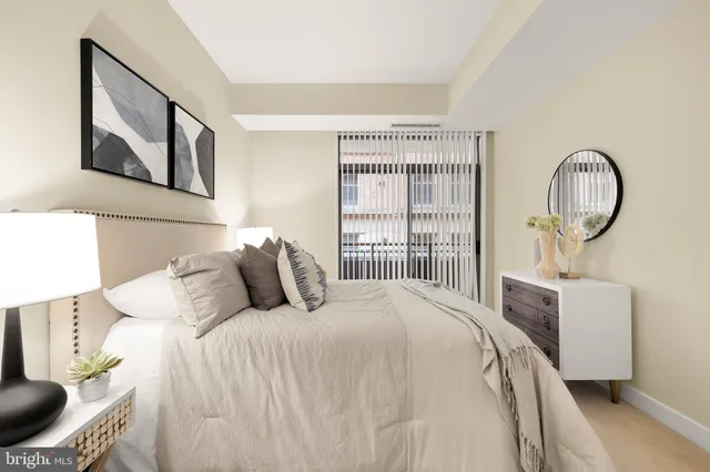 a bedroom with bed and wooden floor