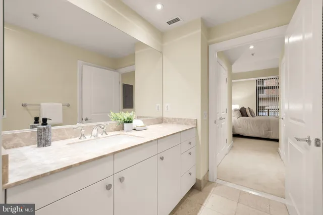 a en suite bathroom with double sink and a mirror