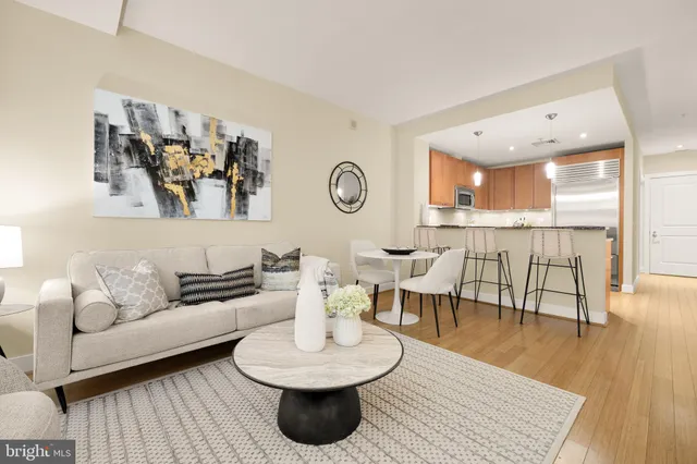a living room with furniture and a wooden floor