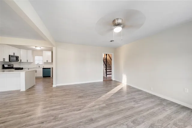 a view of kitchen with cabinets and wooden floor