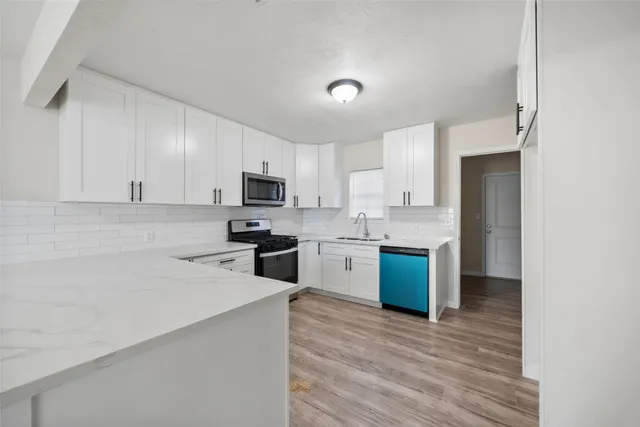a kitchen with a refrigerator sink and microwave