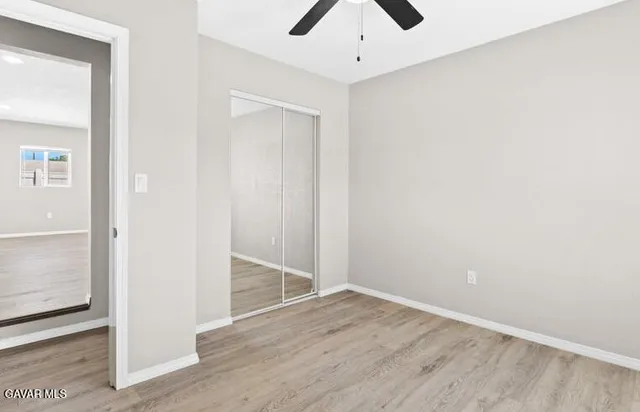 an empty room with wooden floor and door