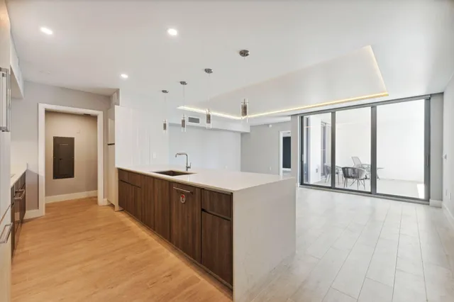 a kitchen with a sink and a refrigerator