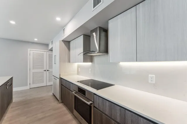 a kitchen with stainless steel appliances a refrigerator and a stove