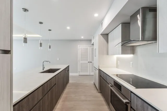 a kitchen with granite countertop a sink and cabinets
