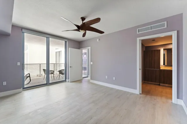 a view of a livingroom with a ceiling fan and window