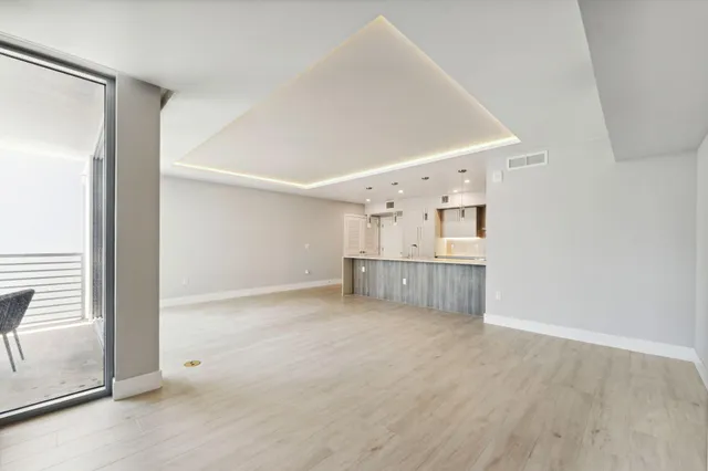a view of a kitchen with a sink and a refrigerator