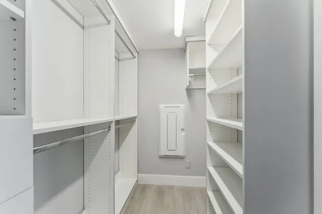 a view of walk in closet with empty racks
