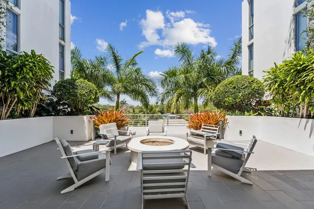 a view of a patio with a table and chairs