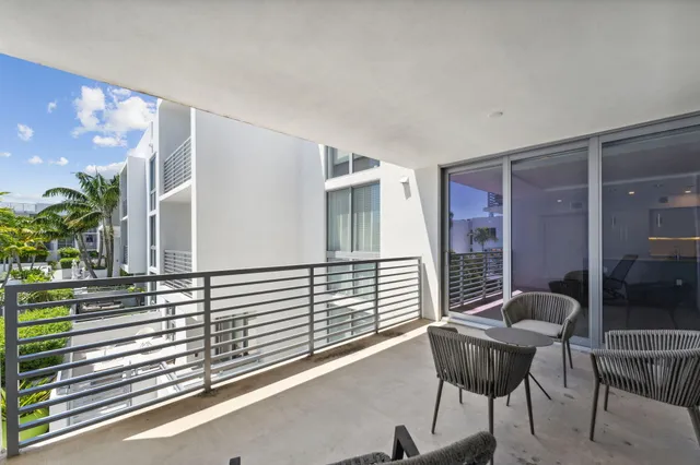 a view of a chair and tables in the balcony