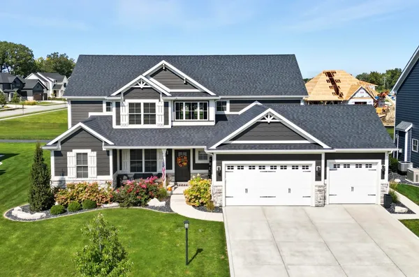 a front view of a house with a yard and garage