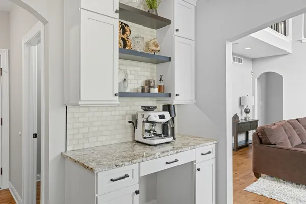a kitchen with stainless steel appliances granite countertop a sink and a stove