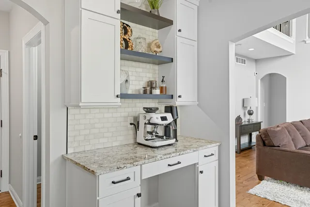 a kitchen with stainless steel appliances granite countertop a sink and a stove