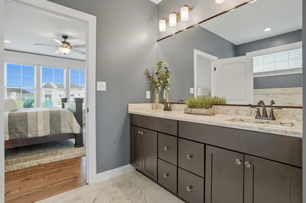 a spacious bathroom with a double vanity sink mirror and double