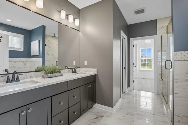 a bathroom with a glass shower door