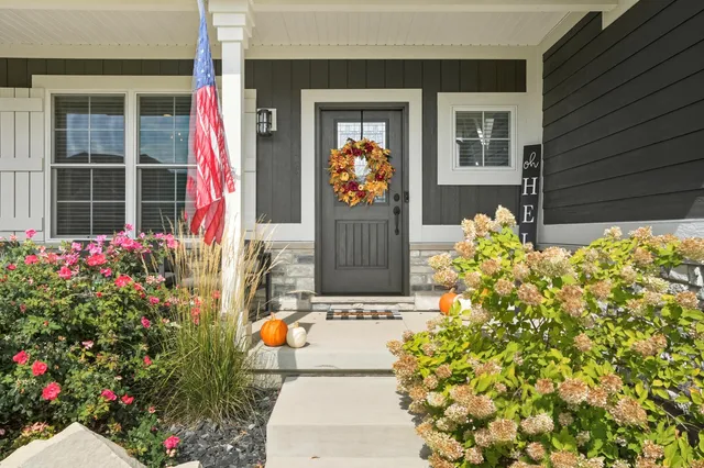 a flower garden is sitting in front of a house
