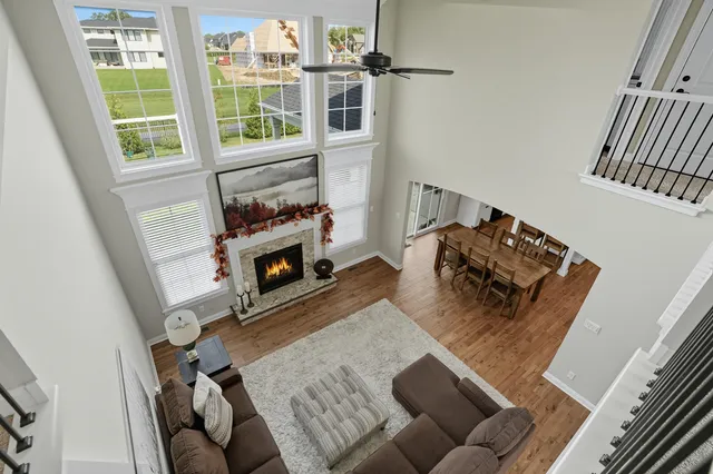 an empty room with windows and ceiling fan