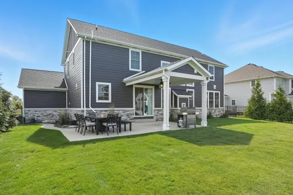an aerial view of residential houses with yard and ocean view