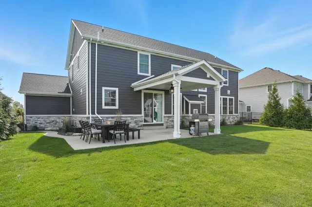 an aerial view of residential houses with yard and ocean view