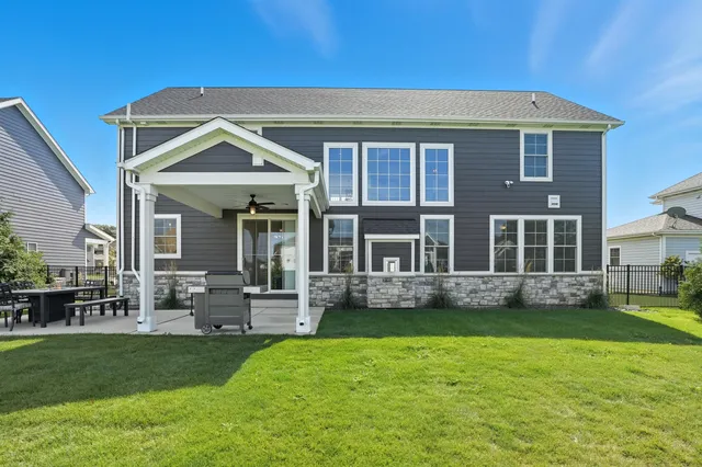 an aerial view of a house with a swimming pool yard and outdoor seating