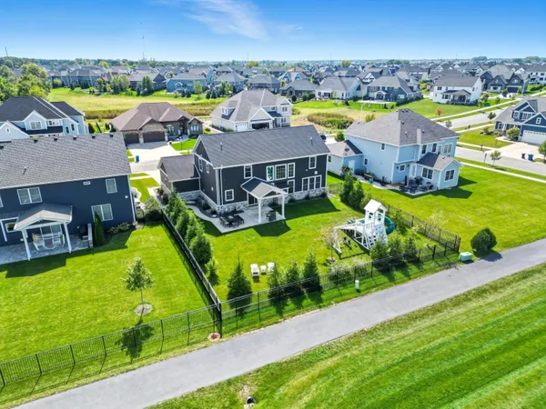an aerial view of residential houses with outdoor space and swimming pool