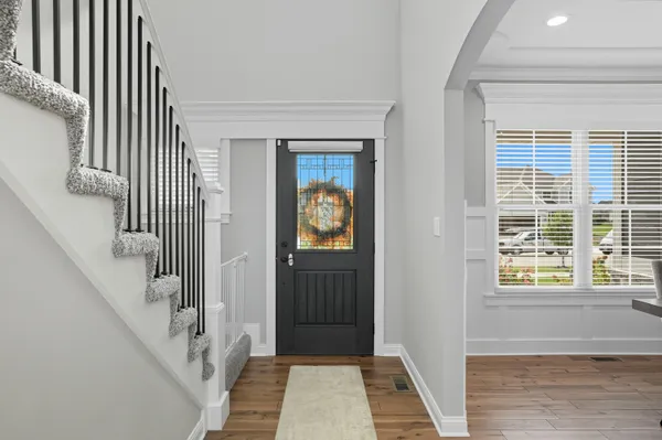 a view of a hallway with windows and stairs