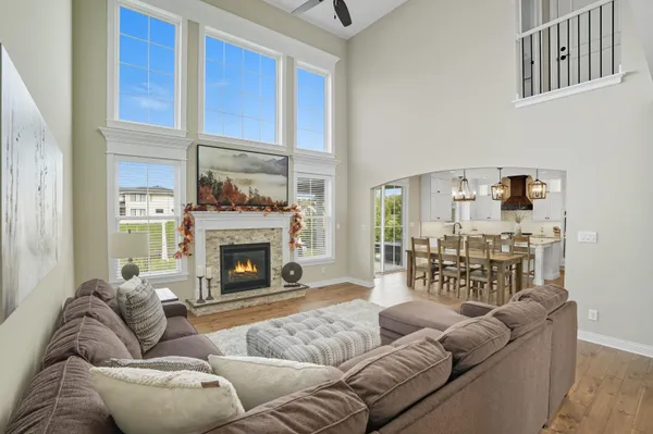 a living room with furniture a fireplace and a large window