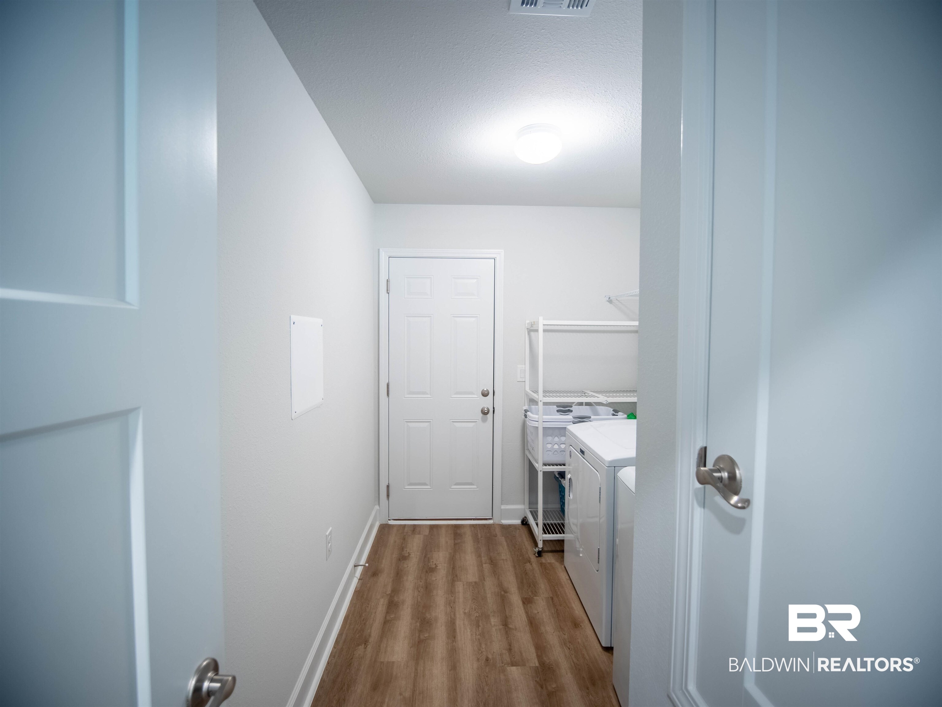 12646 Michigan Avenue Elberta, AL 36530 - Photo 32 of 47 Laundry room with independent washer and dryer and dark wood-type flooring
