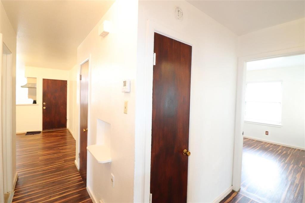 9107 Rustown Drive Dallas, TX 75228 - Photo 16 of 30 a view of a hallway with wooden floor